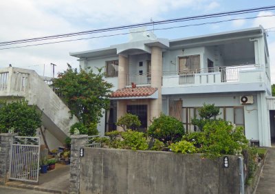 Modern house on Okinawa Island with shi-shi over the entrance