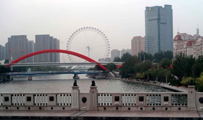 Tianjin Eye is a 394 ft tall Ferris wheel  above the Yongle Bridge over the Hai River in Tianjin, China