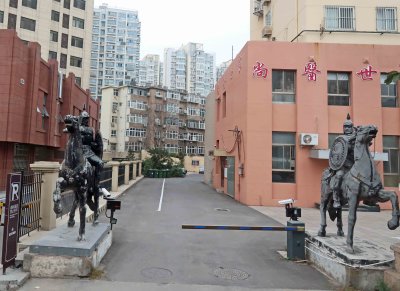 Statues at entrance to apartment complex in Qingdao