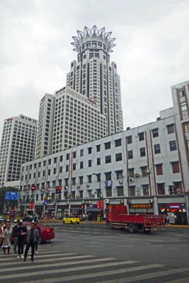 The Bund Centre Building in Shanghai is topped with a crown in the shape of a lotus flower