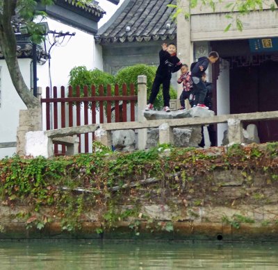 Boys playing along the Grand Canal in Suzhou, China