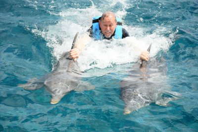 Bill riding two dolphins