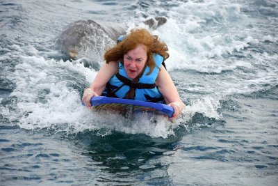 Susan being pushed by a dolphin