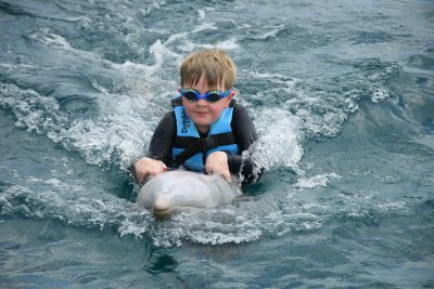 William riding a dolphin