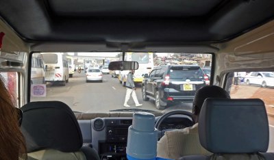 People in Nairobi cross three lanes of highway traffic