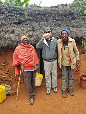 Bill drinking with two elders from the community