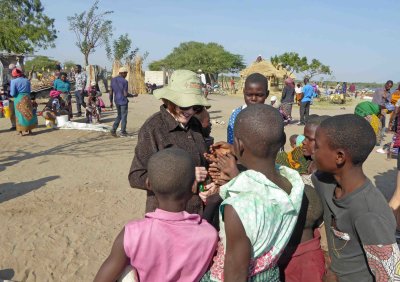 Susan with lollipops for kids in Lake Victoria village