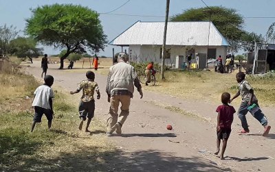 Bil playing soccer in Lake Victoria village