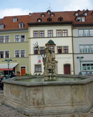 Neptune Fountain in front of pharmacy operating since 1567 in Weimar, Germany