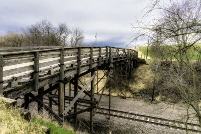 It has been a long time since any work has been done on this bridge. The rail line however has been reworked since it was install.

An image may be purchased at edward-peterson.pixels.com/featured/wagon-bridge-over-rai...