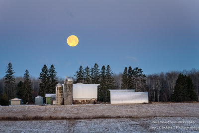 Full moon setting behind a farmstead 2