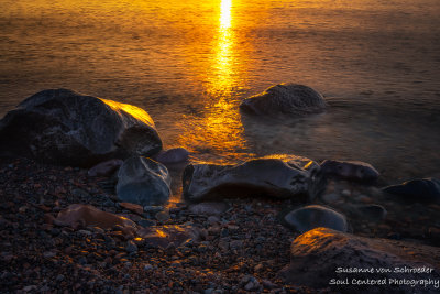 Lake Superior sunrise in orange, sunlit rocks