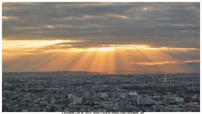 Sunset crepuscular rays in Shinjuku, Japan