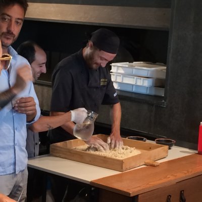 Showing how they make the pizzia dough