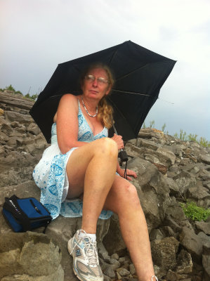 Sitting on a hard old rock, and then it rains.   Not happy.