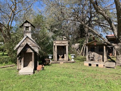 Small church and structures made with recycled pallets and old wooden fences. Lockhart, TX
