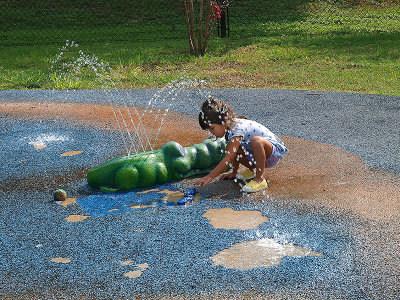 Little girl playing in Splash Pad at Fisherman's Park