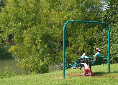 Llittle girl pushing swing at Fisherman's Park