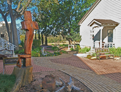 Cross with garden in background.