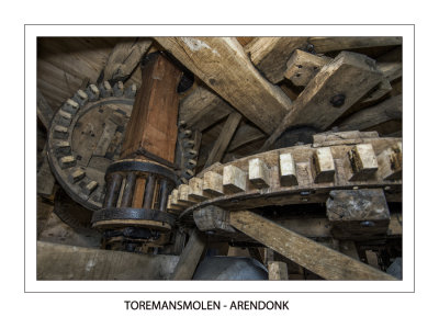 The small lantern gear is mounted on the wooden shaft coming from above