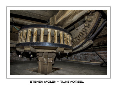 The large lantern wheel mounted on top of the vertical shaft