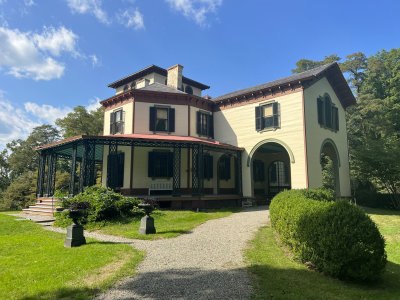 View with the covered porch wrapping around the mansion.