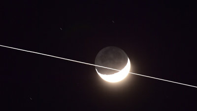 The International Space Station crossing the Waxing Crescent Moon
