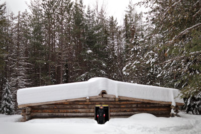 Show-covered cabin in the woods