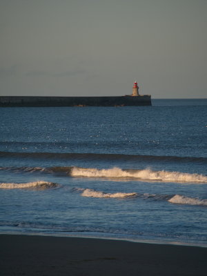 Tynemouth south pier lit up by the day's last sunrays