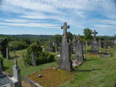 Ollomont cemetery against the Ardennes forested landscape