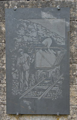 Plaque showing miner at work