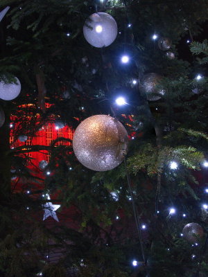 Christmas baubles against the illuminated Town Hall