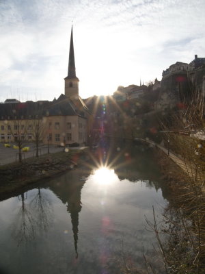 The sun reflected in the Alzette river next to Eglise St Jean