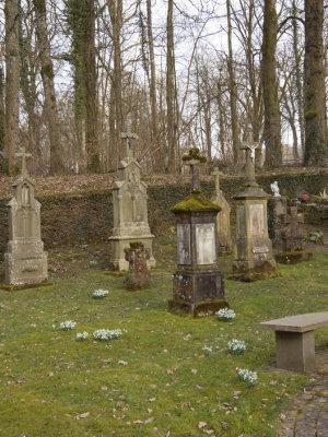 Tombstones in a secluded graveyard in the forest surrounding Castle Meysembourg