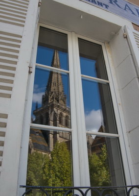 Reflection of the cathedral spire in a restaurant window