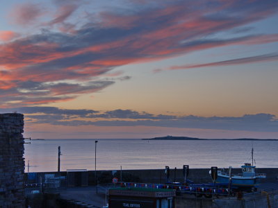 Seahouses harbour with Inner Farne lighthouse in operation