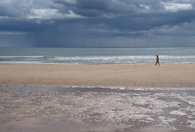 Lone wanderer as a storm is brewing over the North Sea