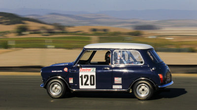 A slightly blurry pan shot of a Mini.