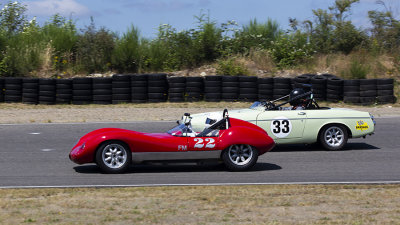 1960 lola Mk I passing a Datsun on the inside of turn two.