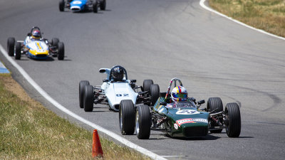 Formula Fords lead by a Lola 