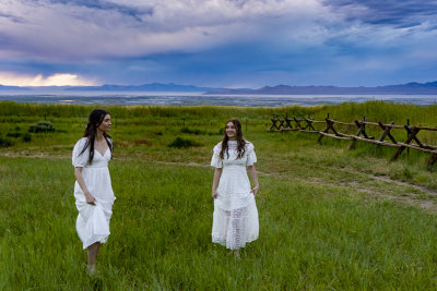 2 ladies in a meadow overlooking the Great Salt Lake.