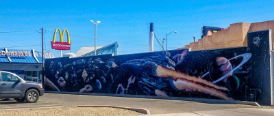 Beautiful large outer space mural painting on wall near McDonald’s