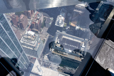 Standing on glass part of floor 1,131 up and looking down at street below.
