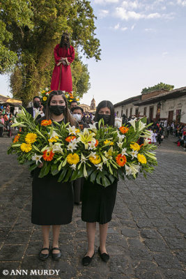 Women carrying flowers in procession