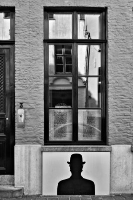 Reflections on a man in a bowler hat