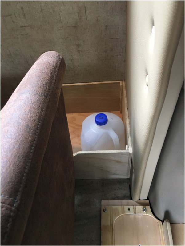 Storage behind seats - Sized for water jugs