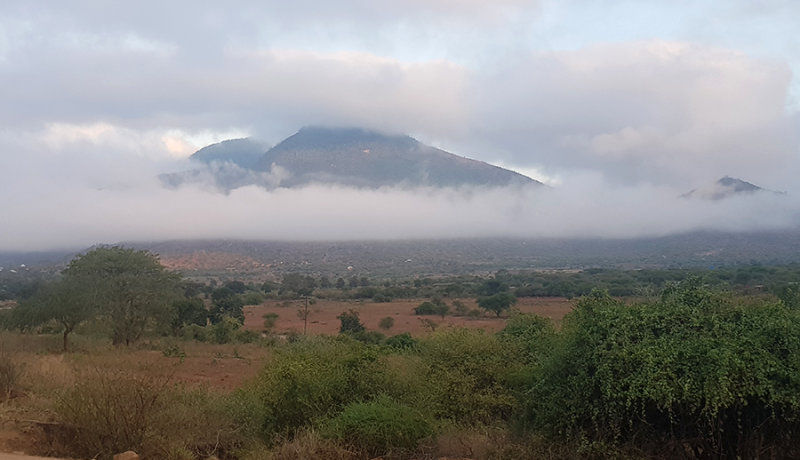 Arusha is on a high plateau with peaks rising from it.