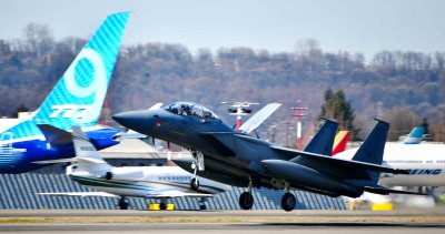 Boeing F-15 landing at Boeing Field and Boeing 777-9 in the background, Seattle, Washington 097