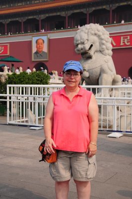 Michelle outside the Forbidden City with a Lion and Chairman Mao
