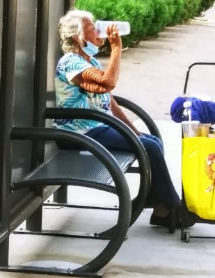 Senior homeless trying to hydrate in record July heatwave. Phoenix Arizona
